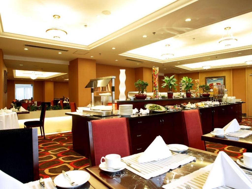 a restaurant with a buffet line in a hotel at Argyle International Airport Hotel Shanghai in Shanghai