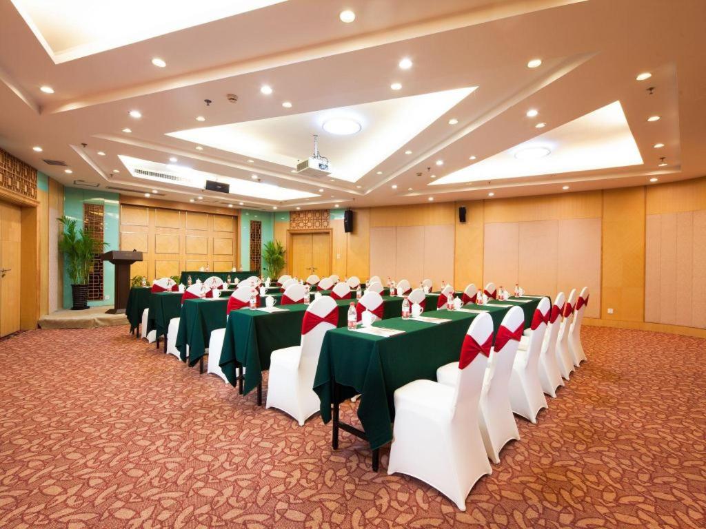 a banquet hall with green and white tables and chairs at Argyle International Airport Hotel Shanghai in Shanghai