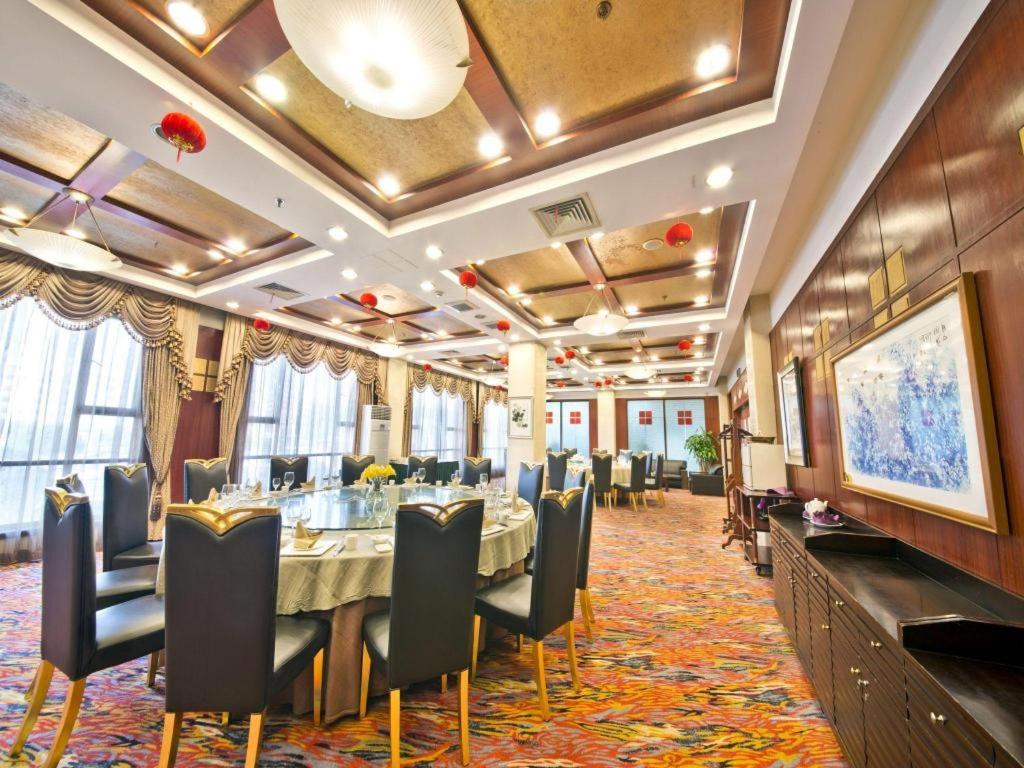 a dining room with a long table and chairs at Argyle International Airport Hotel Shanghai in Shanghai
