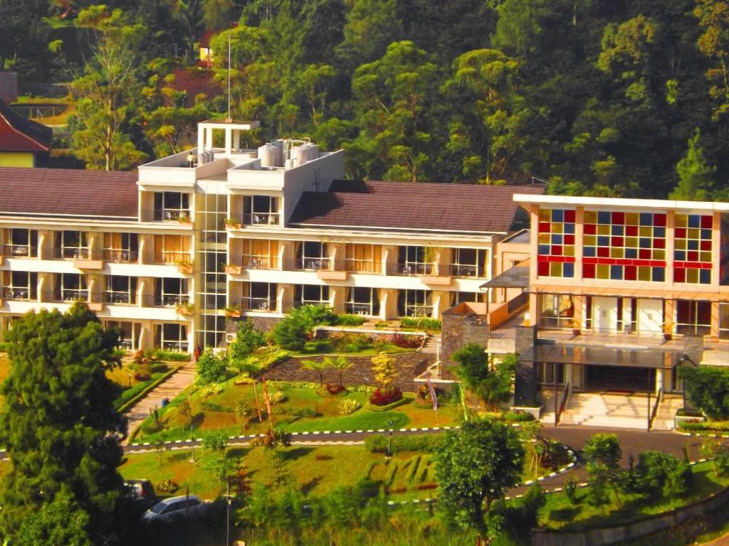 a large building with a garden in front of it at Casa Monte Rosa in Puncak