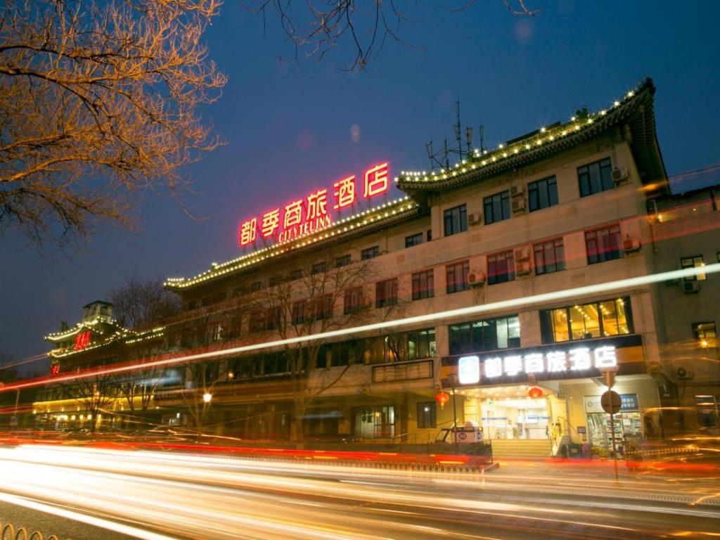 a building with neon signs on the side of it at Citytel Inn in Beijing