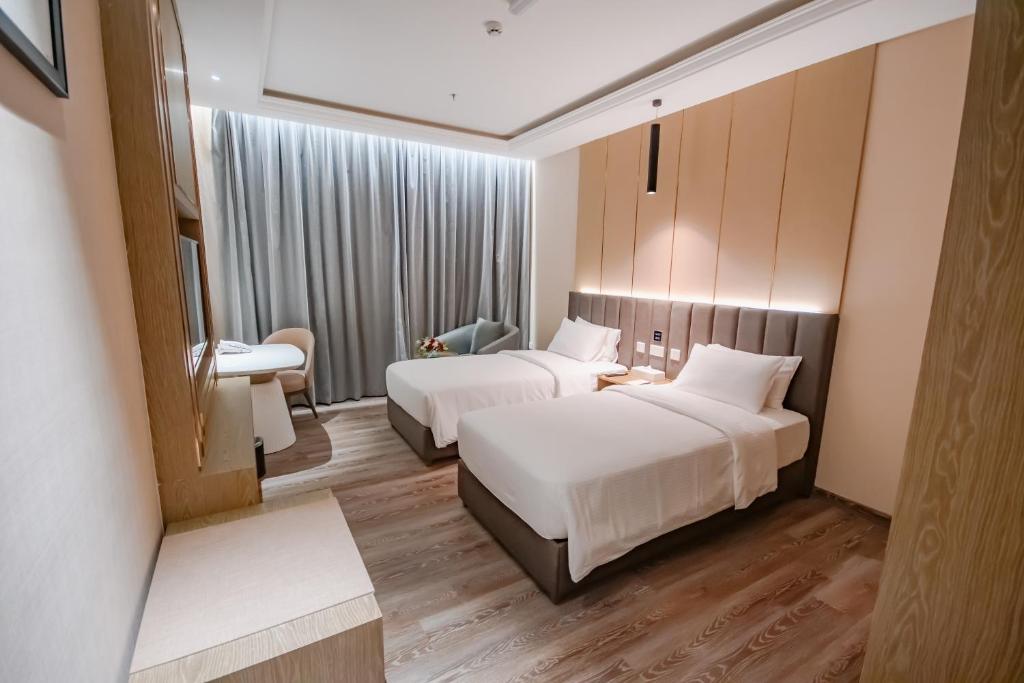 Postel nebo postele na pokoji v ubytování Frankincense Hotel Muscat فندق اللبان مسقط