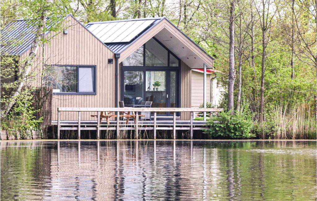 a cabin on a dock next to a body of water at Cozy Home In Oosterwolde With Sauna in Oosterwolde