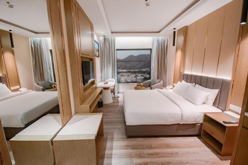 Postel nebo postele na pokoji v ubytování Frankincense Hotel Muscat فندق اللبان مسقط