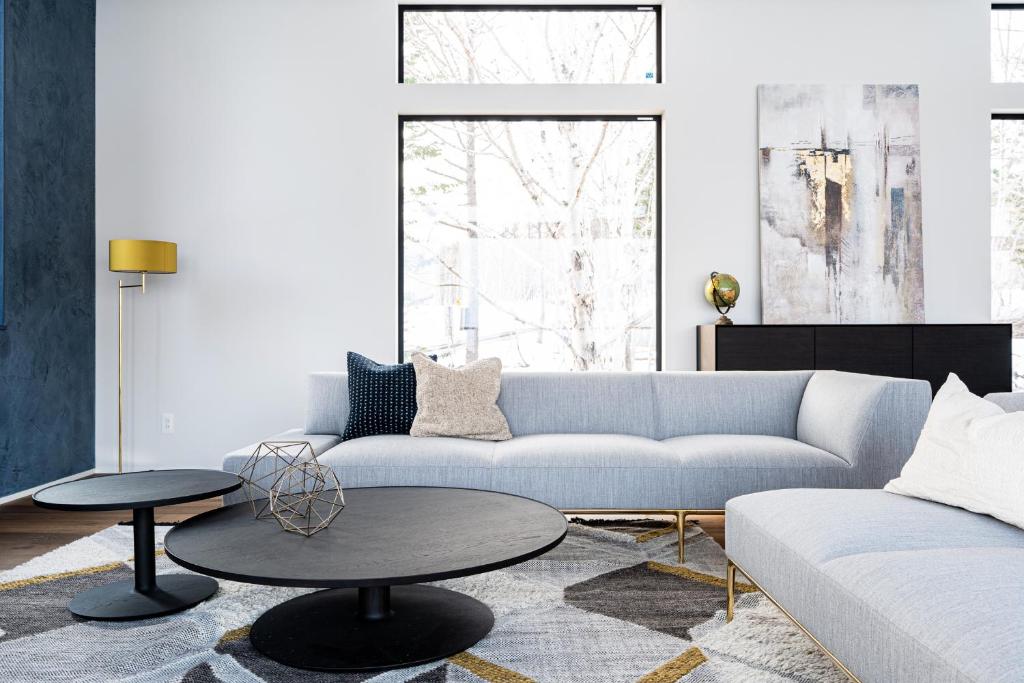 a living room with a couch and a table at Hiiragi by H2 Life in Niseko