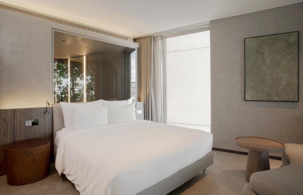 Giường trong phòng chung tại M Hotel Danang