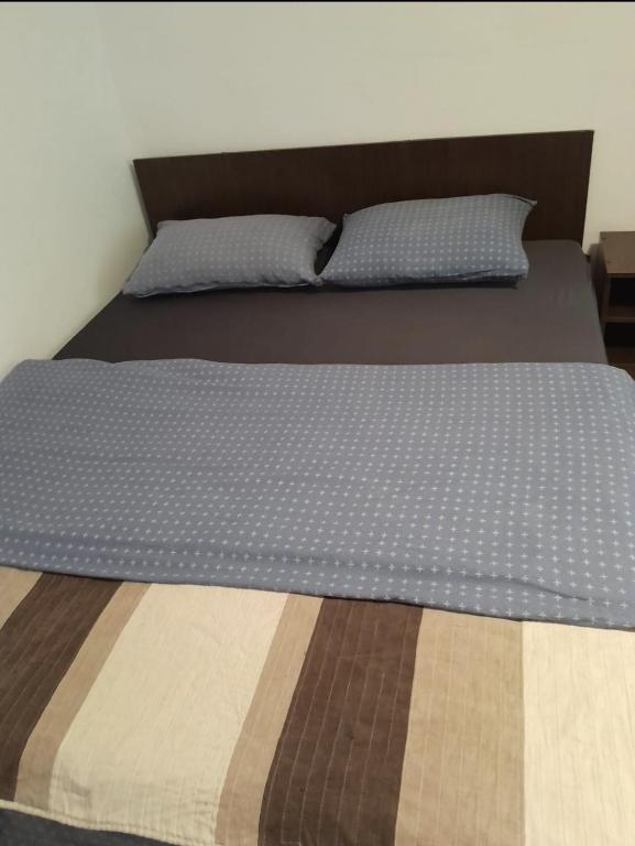 a bed with two pillows on top of it at Farmec vintage2 in Cluj-Napoca