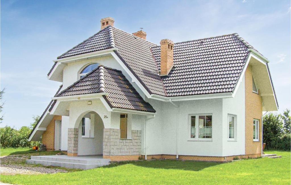 a small white house with a roof at 3 Bedroom Awesome Home In Postomino in Postomino