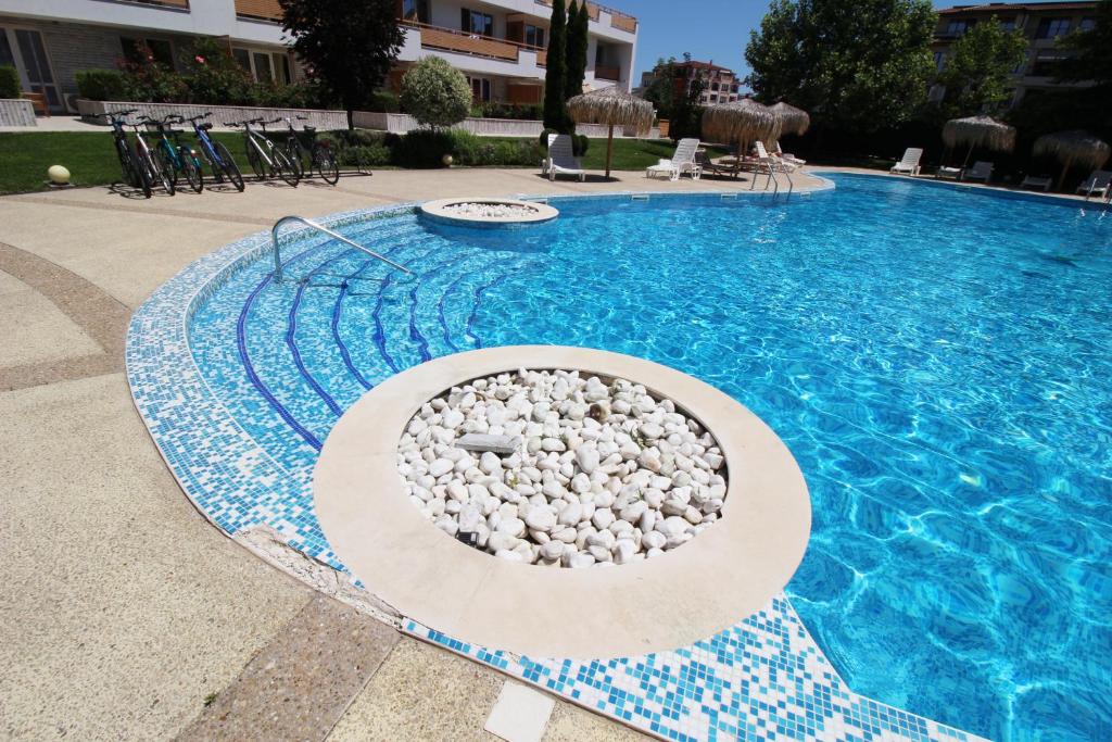 a swimming pool with rocks in the middle of it at Doris Beach apartment D06 in Burgas City