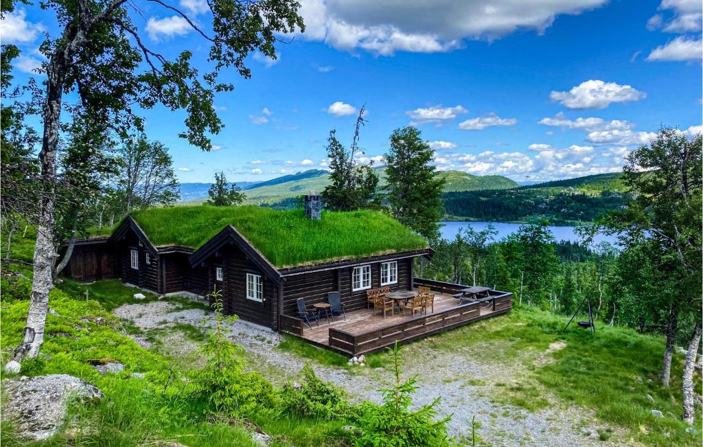 a log cabin with a grass roof at Holiday Home Flå Øvre Reinsjøfjell in Stamn