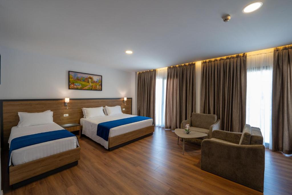 Postel nebo postele na pokoji v ubytování Acros Resort