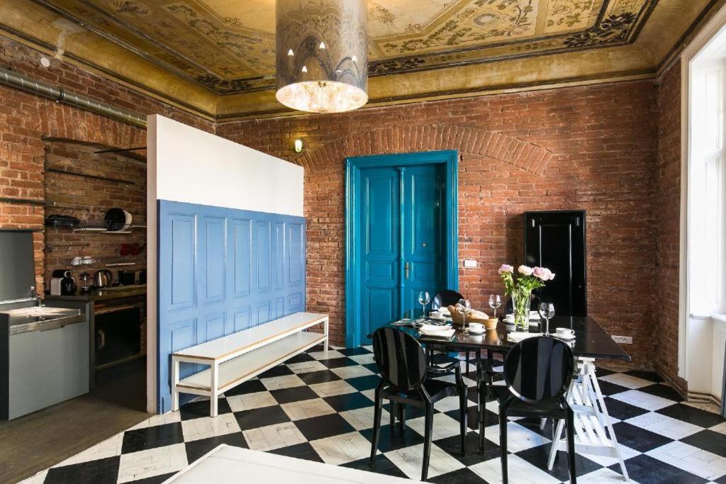 a dining room with a table and a blue door at Old Town - Dusni Apartments in Prague