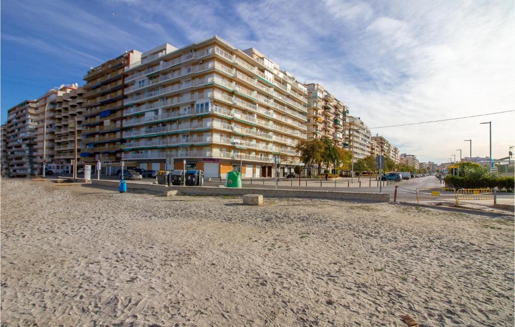 a large apartment building on the beach next to the sand at 2 Bedroom Cozy Apartment In Santa Pola in Santa Pola