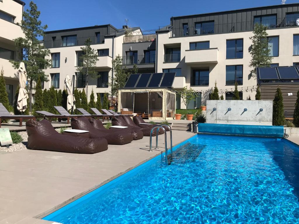 a pool with a slide and a water park at Malūno vilos in Palanga