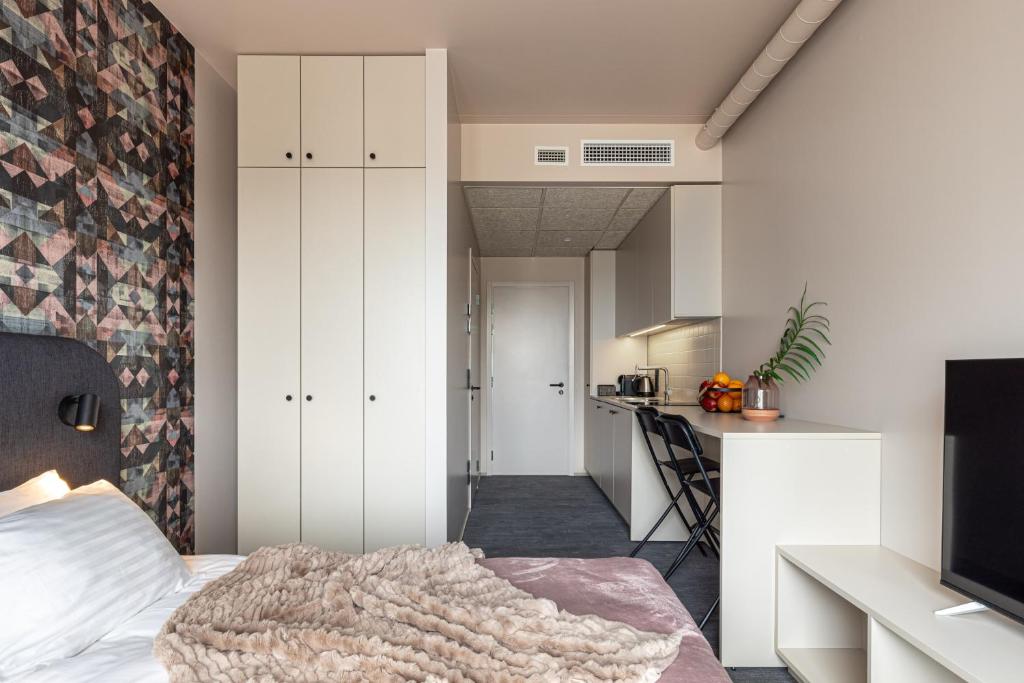 Postel nebo postele na pokoji v ubytování Hugo Apartment Hotel