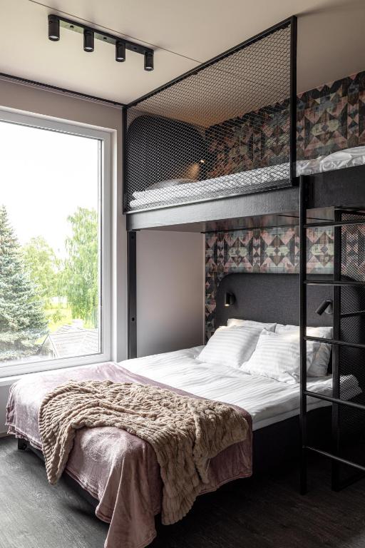 Postel nebo postele na pokoji v ubytování Hugo Apartment Hotel