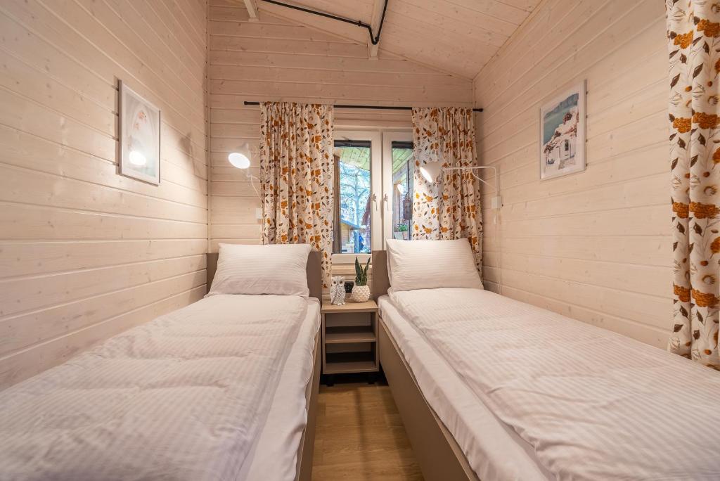 Postel nebo postele na pokoji v ubytování Domki - Sosnowy Las