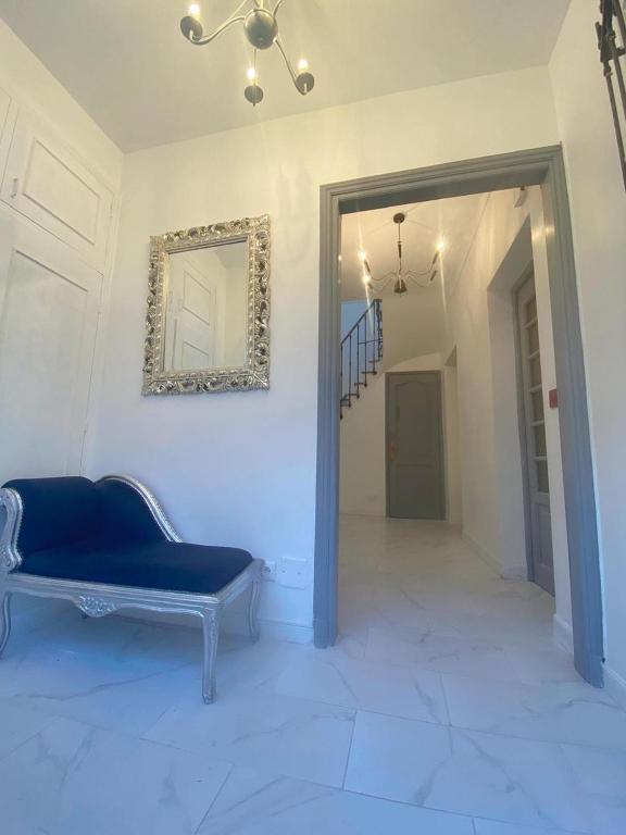 un salon avec un canapé bleu et un miroir dans l'établissement Charming house near Center Nice with new air conditioner, à Nice