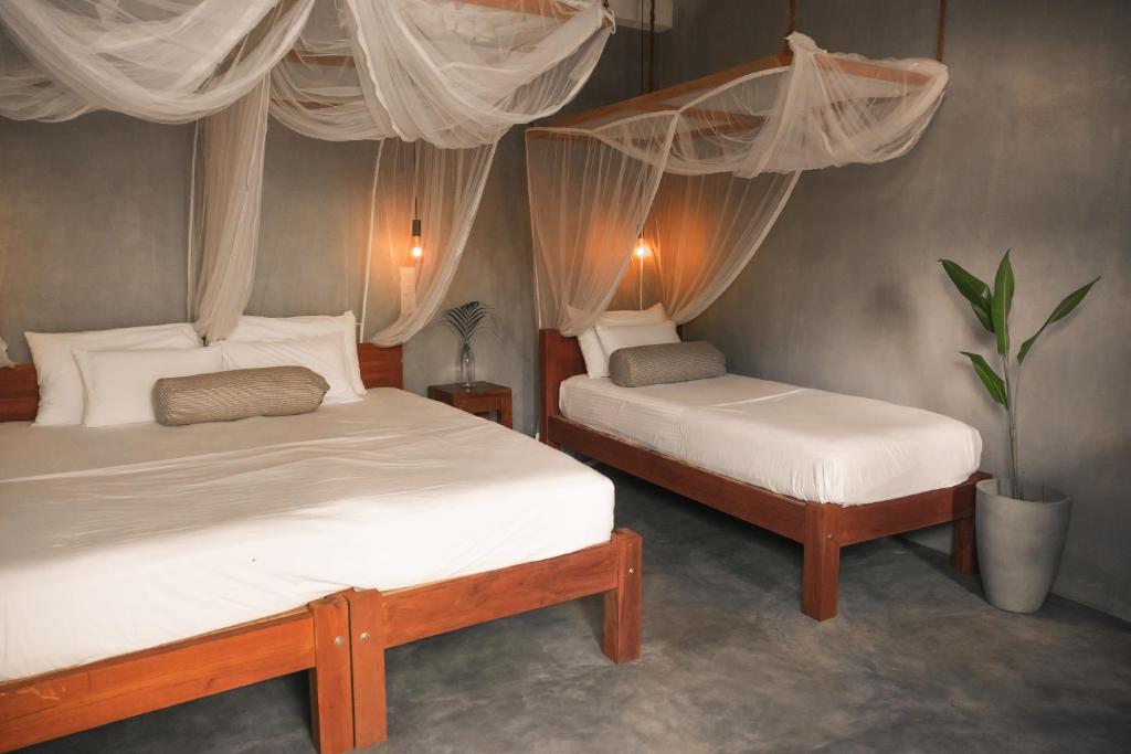 Postel nebo postele na pokoji v ubytování Jamu Surf Lodge