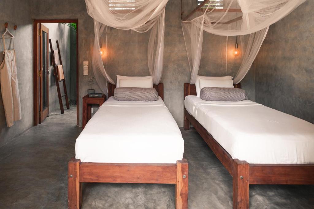 Postel nebo postele na pokoji v ubytování Jamu Surf Lodge