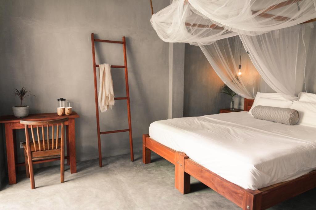 Postel nebo postele na pokoji v ubytování Jamu Surf Lodge