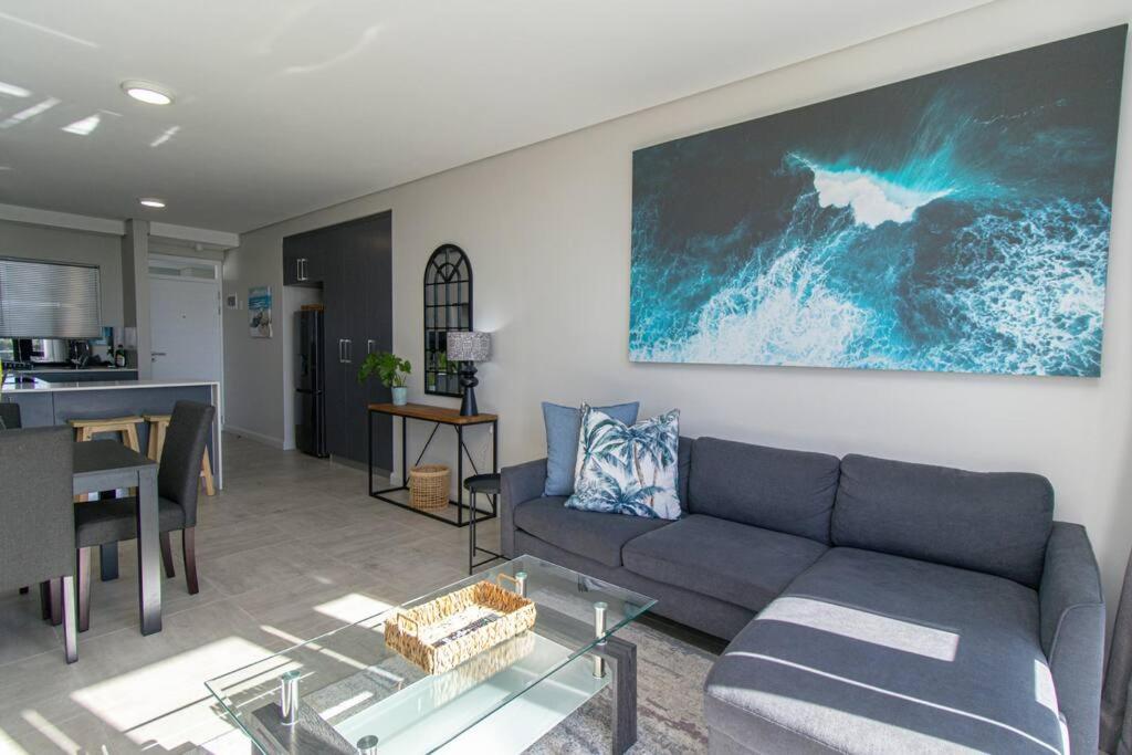 a living room with a couch and a table at Bella Mare 13 on Boardwalk in Gqeberha