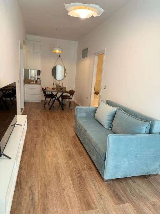 a living room with a blue couch and a table at Saint 40 Suites Premium Flat in Sarandë