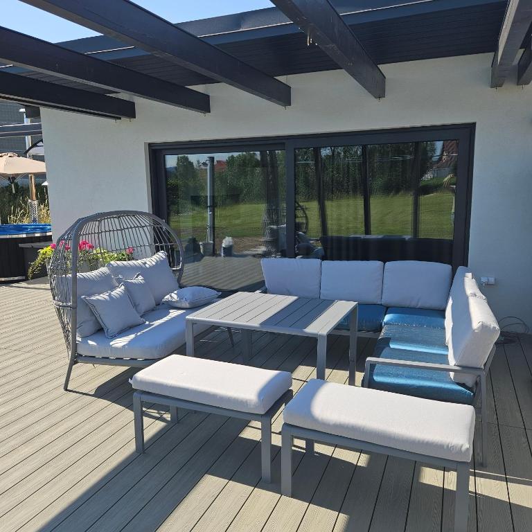 a patio with blue and white furniture and a table at TinyApartament in Skawa