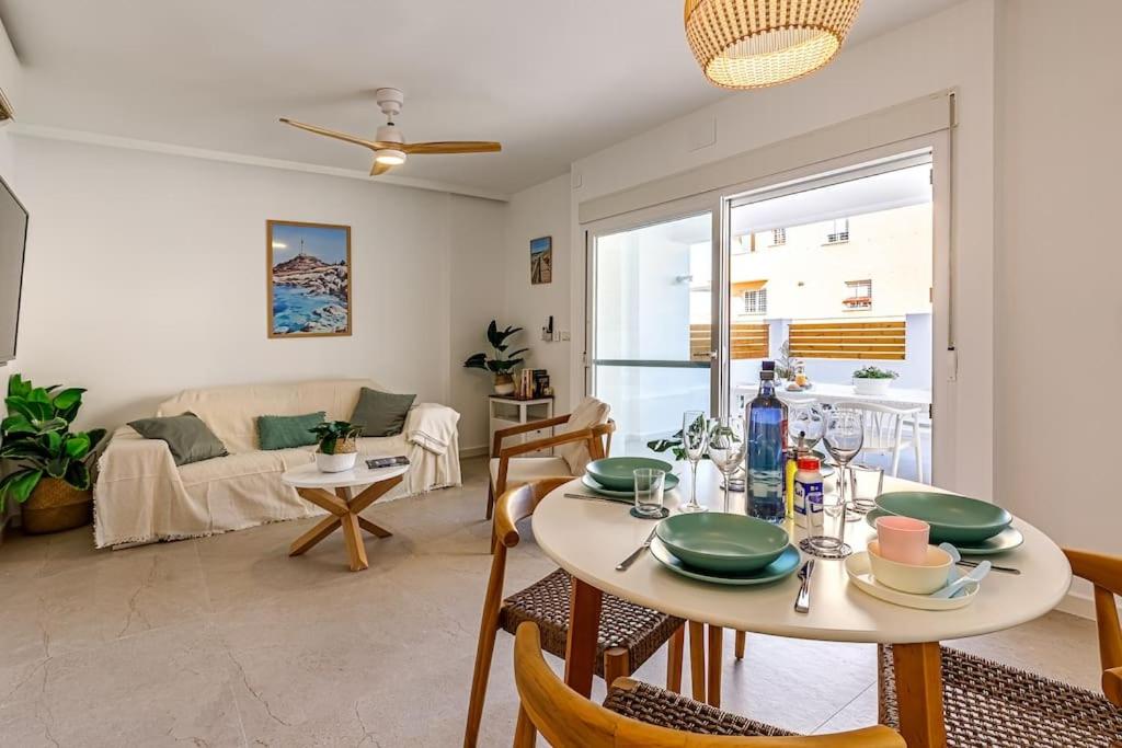 a dining room and living room with a table and chairs at La Capilla del Cabo Apt 3 in Cabo de Palos