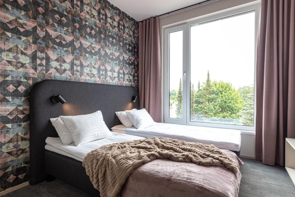 Postel nebo postele na pokoji v ubytování Hugo Apartment Hotel