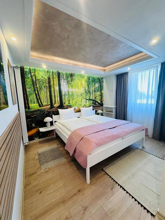 a bedroom with a large bed with a large window at Villa Helvetia in Târgu-Mureş