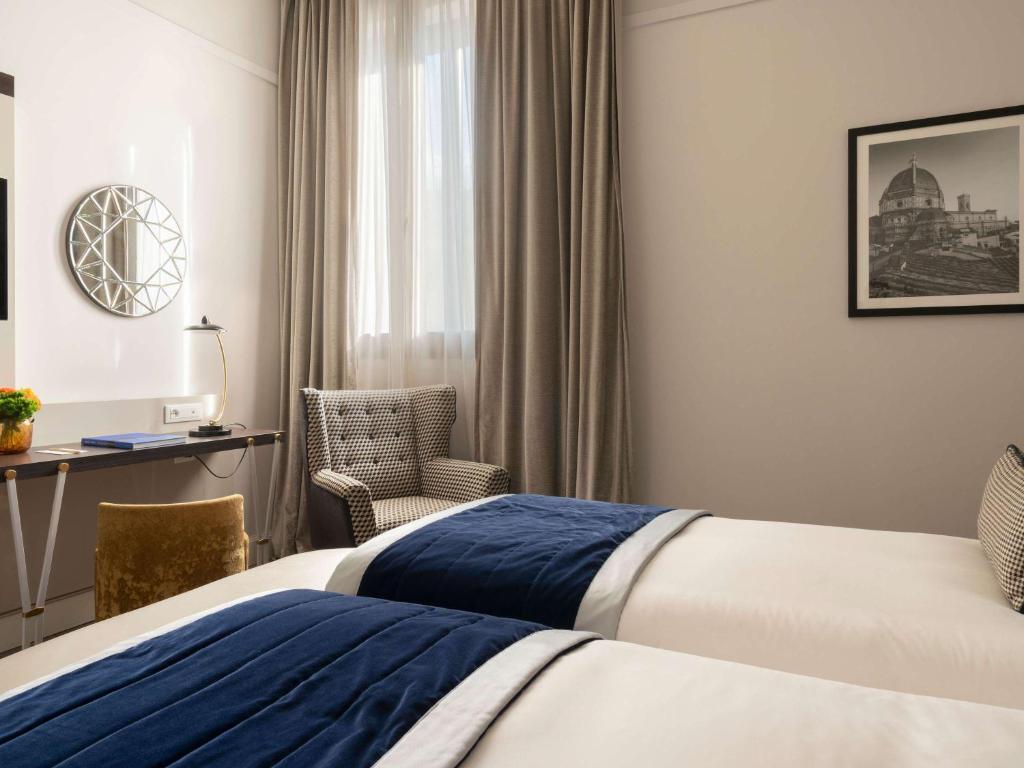 Postel nebo postele na pokoji v ubytování Cerretani Hotel Firenze - MGallery Collection