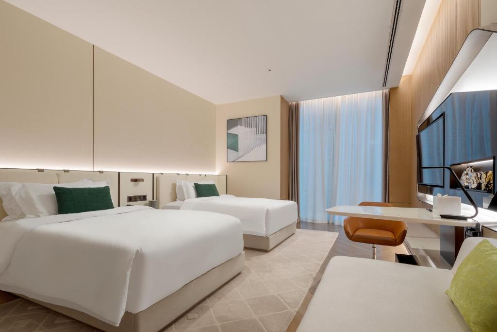 Postel nebo postele na pokoji v ubytování Shenzhen Ayearn Hotel