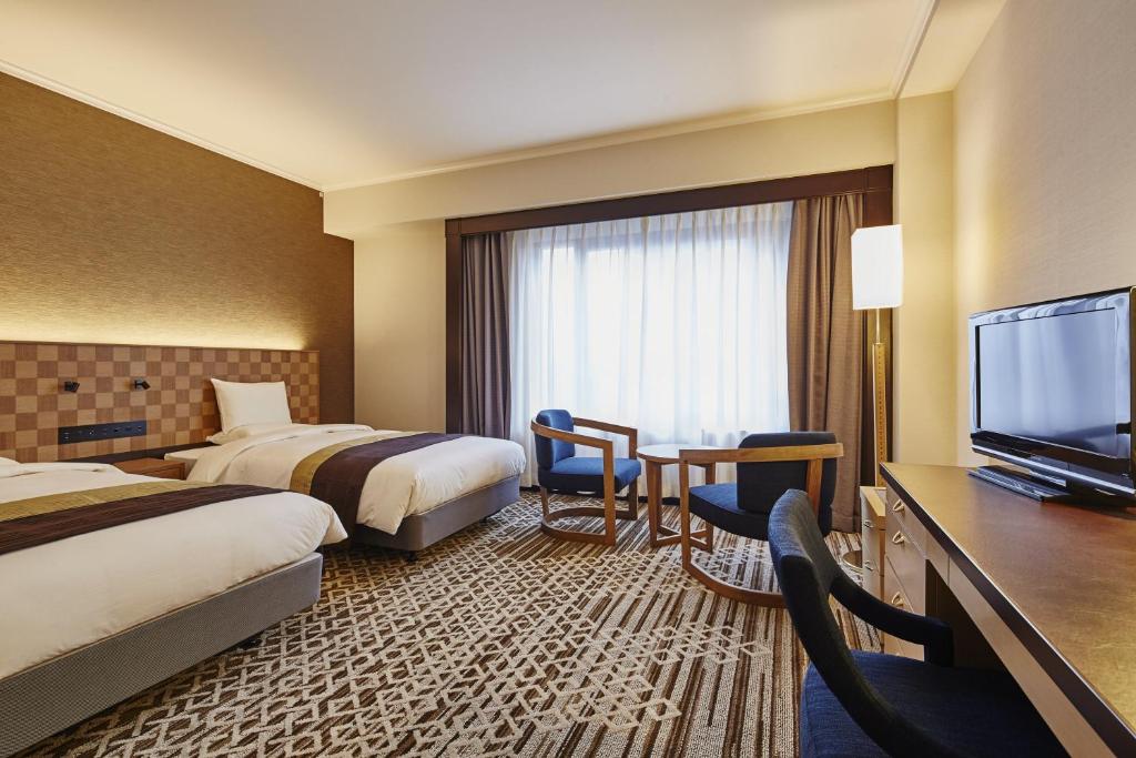 Postel nebo postele na pokoji v ubytování Hotel Nikko Tachikawa Tokyo