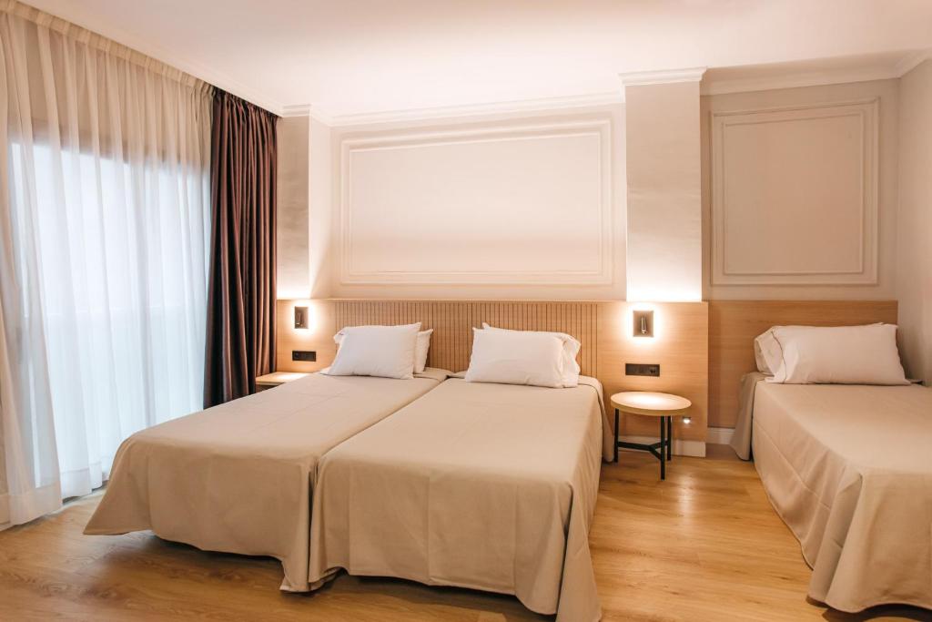 Postel nebo postele na pokoji v ubytování Hotel Miramar