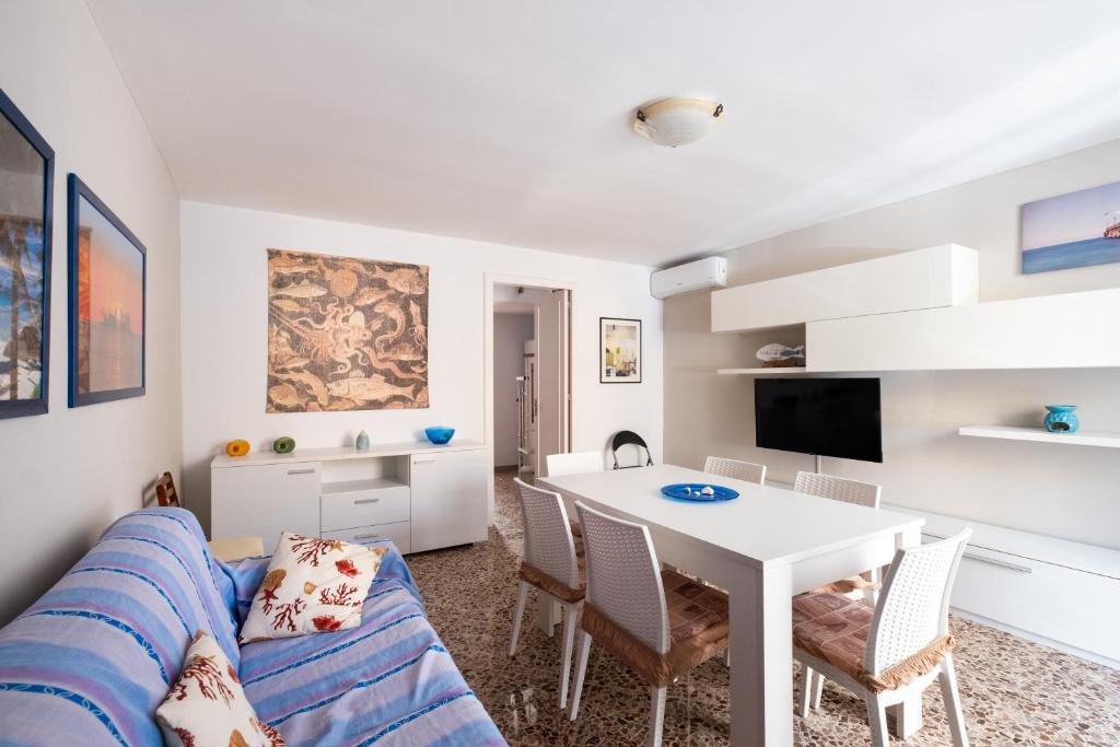 a living room with a couch and a table at Gió home in Santa Maria al Bagno