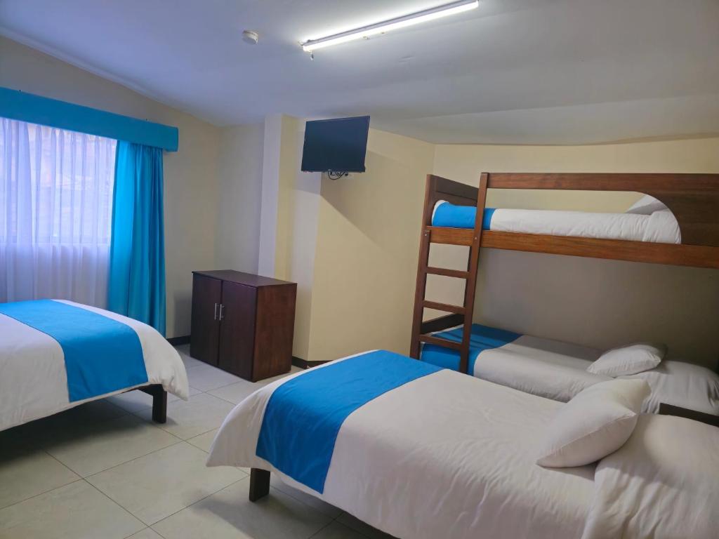 Postel nebo postele na pokoji v ubytování Hotel Tungurahua