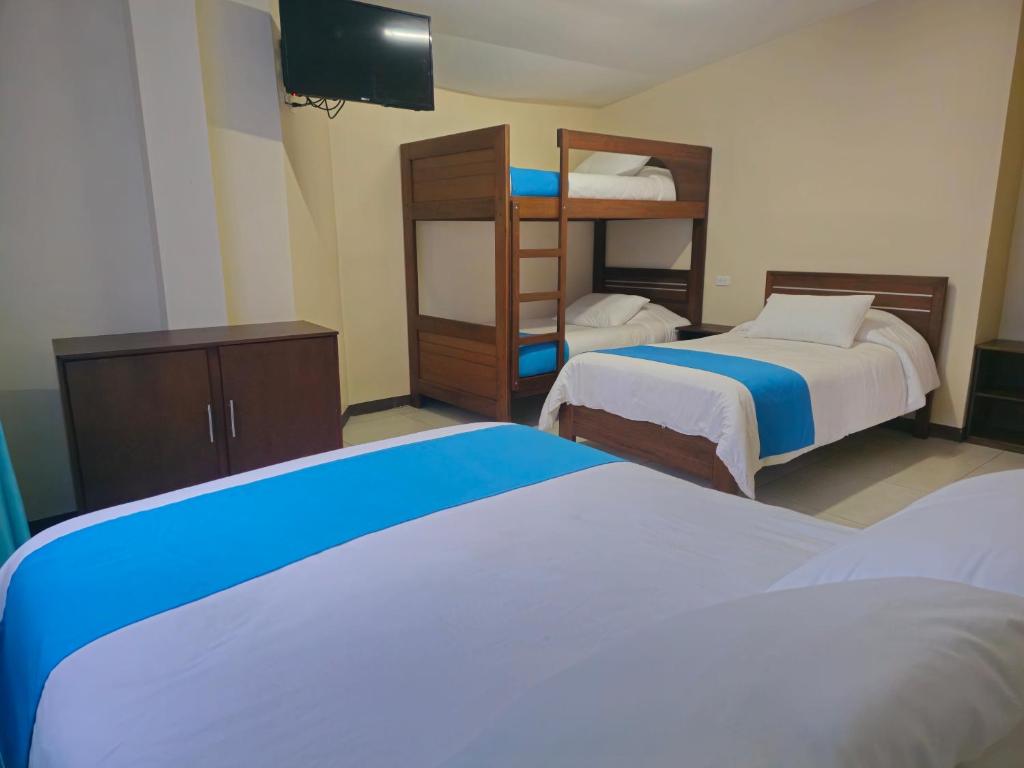 Postel nebo postele na pokoji v ubytování Hotel Tungurahua