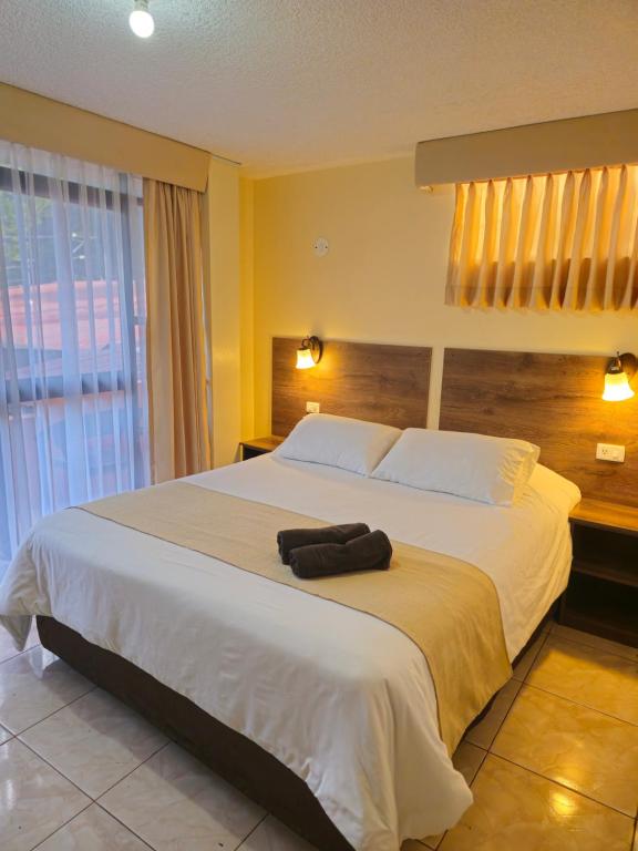 Postel nebo postele na pokoji v ubytování Hotel Tungurahua