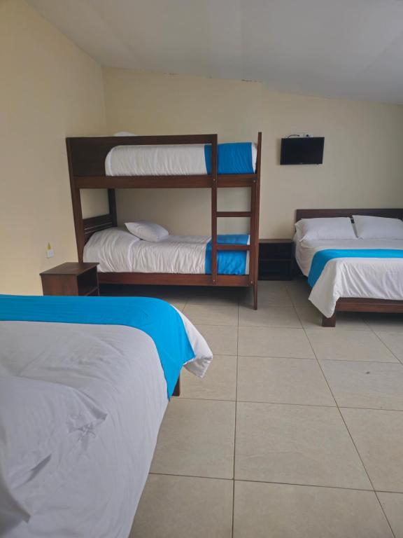 Postel nebo postele na pokoji v ubytování Hotel Tungurahua