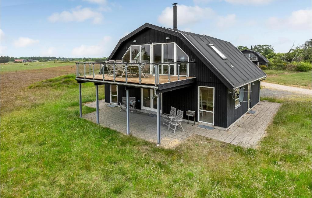 an overhead view of a black house in a field at Four-Bedroom Holiday Home In Skjern in Skjern