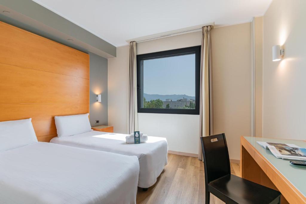 Postel nebo postele na pokoji v ubytování B&B HOTEL Pisa Airport