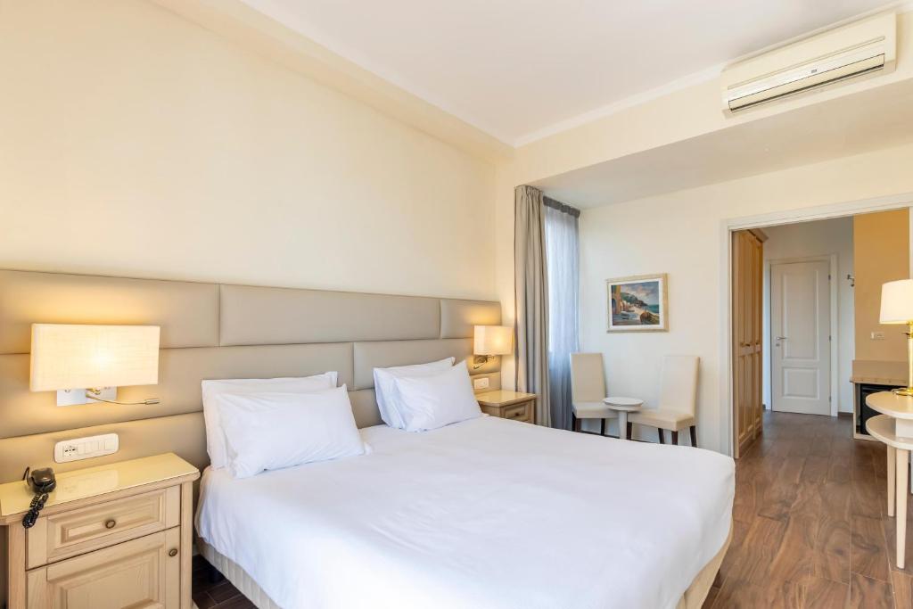 A bed or beds in a room at B&B HOTEL Diano Marina Palace