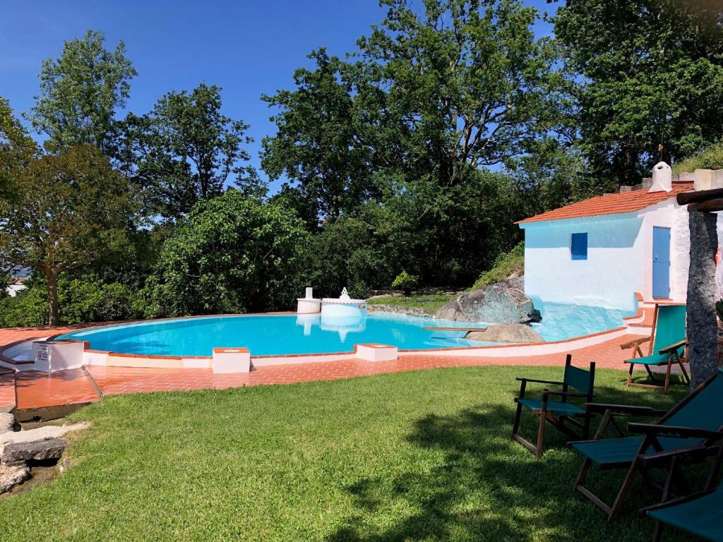 a swimming pool in the backyard of a house at Casa da Agrela in Ponte da Barca