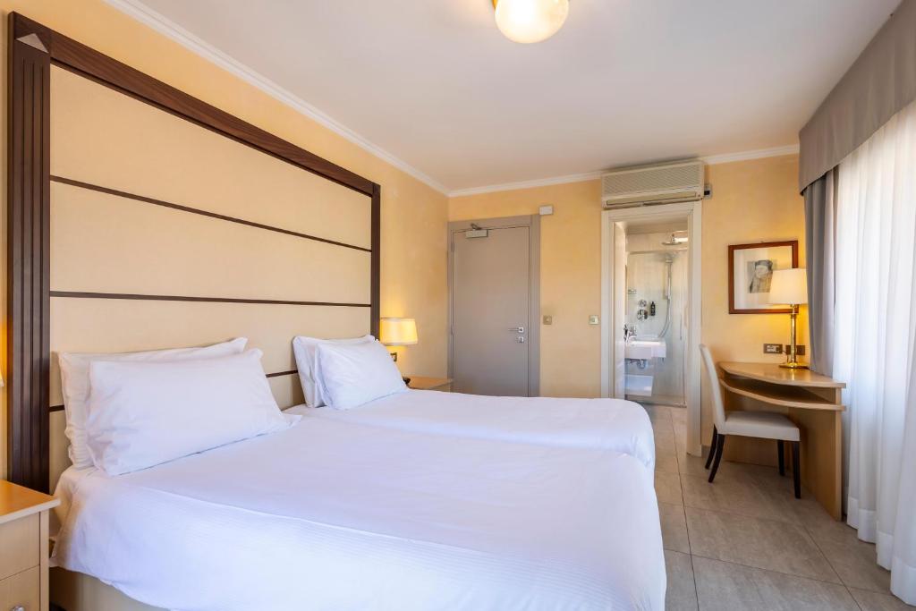 A bed or beds in a room at B&B HOTEL Diano Marina Palace