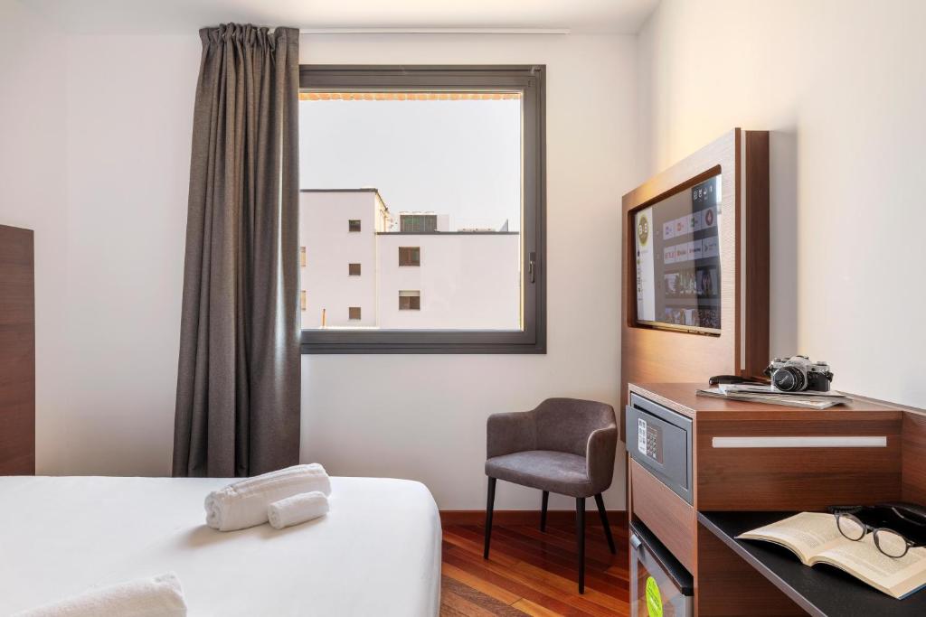 A bed or beds in a room at B&B Hotel Sassuolo