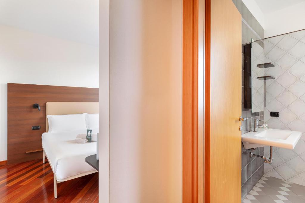A bed or beds in a room at B&B Hotel Sassuolo