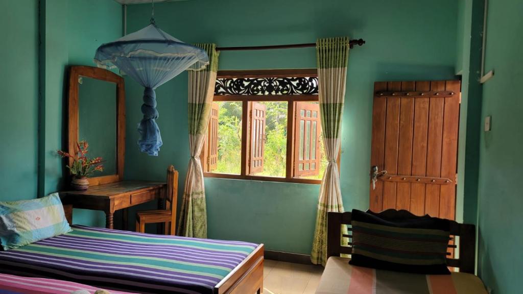 Postel nebo postele na pokoji v ubytování Thomasha Homestay Wellawaya