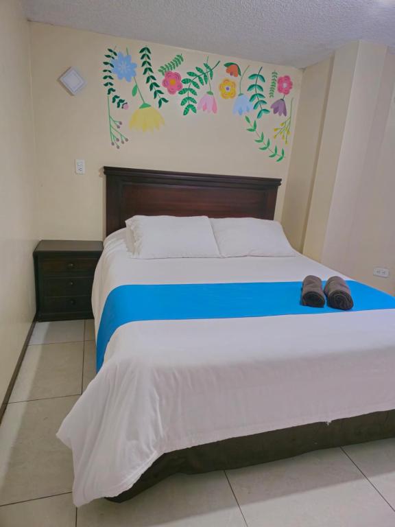 Postel nebo postele na pokoji v ubytování Hotel Tungurahua