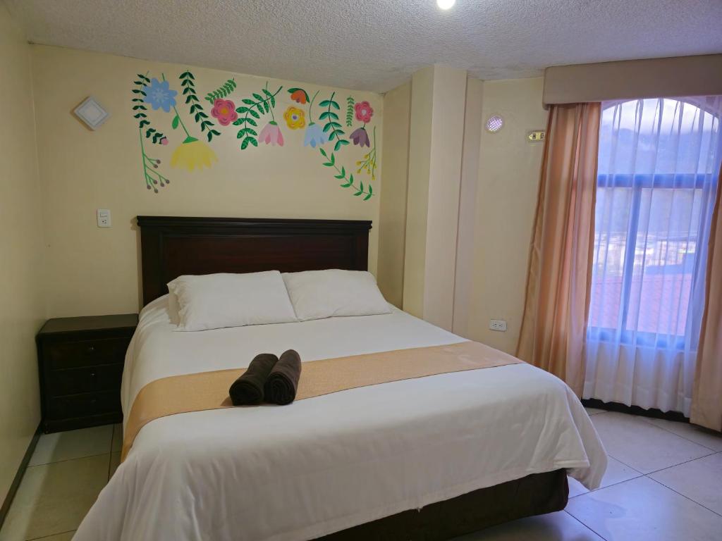 Postel nebo postele na pokoji v ubytování Hotel Tungurahua